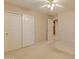 Bedroom featuring carpet flooring and view to bathroom, and large double closet at 7916 W Mary Ann Dr, Peoria, AZ 85382