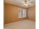 A bright bedroom with a ceiling fan and a window with blinds for natural light and ventilation at 7916 W Mary Ann Dr, Peoria, AZ 85382