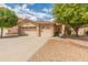 Charming single-story home with a well-maintained front yard, desert landscaping, and a three-car garage at 7916 W Mary Ann Dr, Peoria, AZ 85382