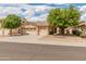 Charming single-story home with a well-maintained front yard, desert landscaping, and a three-car garage at 7916 W Mary Ann Dr, Peoria, AZ 85382
