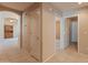 Hallway featuring tile floors and access to multiple rooms at 7916 W Mary Ann Dr, Peoria, AZ 85382