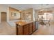 Kitchen with a breakfast bar and stainless steel dishwasher, open to the living spaces at 7916 W Mary Ann Dr, Peoria, AZ 85382