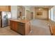 Open kitchen design with stainless steel appliances, island, and access to the dining area at 7916 W Mary Ann Dr, Peoria, AZ 85382