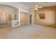 Bright living area featuring carpet, tile flooring, neutral paint and archways; kitchen reflected in mirror adds depth at 7916 W Mary Ann Dr, Peoria, AZ 85382