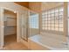 Relaxing main bathroom with a separate tub and shower and a glass block window at 7916 W Mary Ann Dr, Peoria, AZ 85382