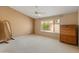 Spacious main bedroom with a ceiling fan, large window, and neutral carpet at 7916 W Mary Ann Dr, Peoria, AZ 85382