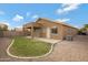 Well-maintained backyard with lush lawn, stone border, gravel area, and covered patio at 881 W Saragosa St, Chandler, AZ 85225