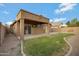 A large grassy area is the focus of the back yard which also contains a covered patio at 881 W Saragosa St, Chandler, AZ 85225