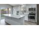 Updated kitchen with white cabinets, quartz countertops, stainless steel appliances, and an island at 881 W Saragosa St, Chandler, AZ 85225