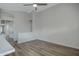 Bright living room with modern gray walls, light wood-look floors, and a ceiling fan at 881 W Saragosa St, Chandler, AZ 85225