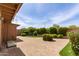 Private brick patio with lush landscaping creates a serene outdoor space, perfect for relaxing and entertaining at 9039 E Winchcomb Dr, Scottsdale, AZ 85260