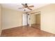 Bedroom featuring hardwood flooring, a ceiling fan, and a mirrored closet at 9039 E Winchcomb Dr, Scottsdale, AZ 85260