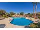 Inviting community pool with comfortable seating and swaying palm trees, creating a relaxing desert oasis at 9039 E Winchcomb Dr, Scottsdale, AZ 85260