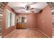 Dining area with wood-look flooring, a ceiling fan, and built-in cabinets at 9039 E Winchcomb Dr, Scottsdale, AZ 85260