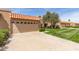 Lovely single-story home with a tile roof and lush green lawn at 9039 E Winchcomb Dr, Scottsdale, AZ 85260