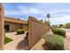 Property exterior featuring brick walkways, lush shrubbery, and desert landscaping for an inviting curb appeal at 9039 E Winchcomb Dr, Scottsdale, AZ 85260