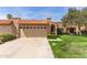 Charming single-story home with a well-manicured lawn and a classic tile roof at 9039 E Winchcomb Dr, Scottsdale, AZ 85260
