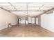 Spacious garage featuring epoxy floor, washer/dryer and extra storage with white cabinets at 9039 E Winchcomb Dr, Scottsdale, AZ 85260