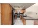 This kitchen features stainless steel appliances, wood cabinets, granite countertops, and modern lighting at 9039 E Winchcomb Dr, Scottsdale, AZ 85260