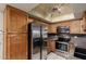 This kitchen features stainless steel appliances, oak cabinets, and modern lighting at 9039 E Winchcomb Dr, Scottsdale, AZ 85260