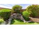 Water feature nestled within lush greenery, enhancing the tranquil outdoor ambiance of this desert home at 9039 E Winchcomb Dr, Scottsdale, AZ 85260