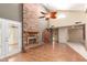 Spacious living room with a striking brick fireplace, vaulted ceilings, and wood floors at 9039 E Winchcomb Dr, Scottsdale, AZ 85260