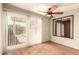 Sun-filled room with sliding glass doors to the backyard and complemented by wood laminate flooring at 9039 E Winchcomb Dr, Scottsdale, AZ 85260