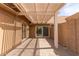 Covered outdoor patio area with stone pavers, pergola, and access to the home at 9039 E Winchcomb Dr, Scottsdale, AZ 85260
