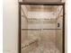 Updated shower features glass doors, tile surround, built-in bench, and mosaic accents at 9039 E Winchcomb Dr, Scottsdale, AZ 85260