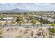 An aerial view of a well-planned community featuring paved roads, desert landscaping, and mountain views at 907 N Mountain Rd, Mesa, AZ 85207