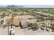 Aerial view showcasing a single story home with an RV, large lot and desert landscaping at 907 N Mountain Rd, Mesa, AZ 85207