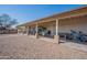 Extensive covered back patio featuring a well-maintained gravel backyard and multiple seating options at 907 N Mountain Rd, Mesa, AZ 85207