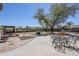 Outdoor patio area featuring a table and chairs, grill, and hammock at 907 N Mountain Rd, Mesa, AZ 85207