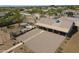 Aerial view showcasing a large covered patio, landscaped backyard, desert-style landscaping, and fire pit area at 907 N Mountain Rd, Mesa, AZ 85207