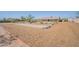 View of backyard showing horseshoe pit and building with covered patio at 907 N Mountain Rd, Mesa, AZ 85207
