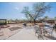 Large backyard featuring a patio with seating, grill, trees, and potential for outdoor activities at 907 N Mountain Rd, Mesa, AZ 85207