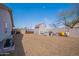 Large backyard featuring a storage shed, RV gate, and wood mulch ground cover at 907 N Mountain Rd, Mesa, AZ 85207