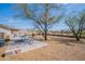 Expansive backyard featuring a large patio, mature trees, and a mulch groundcover, perfect for outdoor living at 907 N Mountain Rd, Mesa, AZ 85207