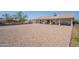 Expansive backyard with gravel and a covered patio, perfect for outdoor enjoyment and relaxation at 907 N Mountain Rd, Mesa, AZ 85207