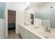 Bathroom featuring dual sink vanity with white countertop, large mirror, and view to bedroom at 907 N Mountain Rd, Mesa, AZ 85207