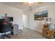 Well-lit bedroom features wood-look tile flooring and a decorative mountain landscape art piece at 907 N Mountain Rd, Mesa, AZ 85207
