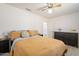 Spacious bedroom with ceiling fan, neutral walls, and dark wood dresser at 907 N Mountain Rd, Mesa, AZ 85207