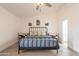 Bedroom with a black metal bed frame, colorful end tables, and matching decor at 907 N Mountain Rd, Mesa, AZ 85207