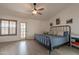 Bedroom featuring a black metal bed frame, neutral decor, and outdoor access at 907 N Mountain Rd, Mesa, AZ 85207