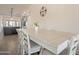 Bright dining area near the kitchen with a neutral table, white chairs, and decor at 907 N Mountain Rd, Mesa, AZ 85207