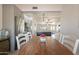 Dining room with rustic wood table, white chairs, and view into modern kitchen area at 907 N Mountain Rd, Mesa, AZ 85207