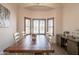 Dining area with bay window, wood table with seating for eight, and stylish decor at 907 N Mountain Rd, Mesa, AZ 85207