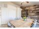 Dining room showcasing wood accent wall, wine cabinet, closet storage, and seating for six at 907 N Mountain Rd, Mesa, AZ 85207