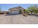 Charming front exterior features a two-car garage, desert landscaping, and inviting curb appeal at 907 N Mountain Rd, Mesa, AZ 85207