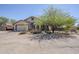 Charming front exterior features a two-car garage, desert landscaping, and ample parking with a desert view at 907 N Mountain Rd, Mesa, AZ 85207